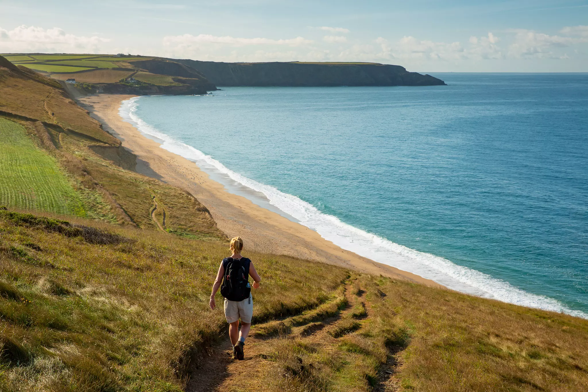 Person walking along a coastal path in New South Wales during morning hours